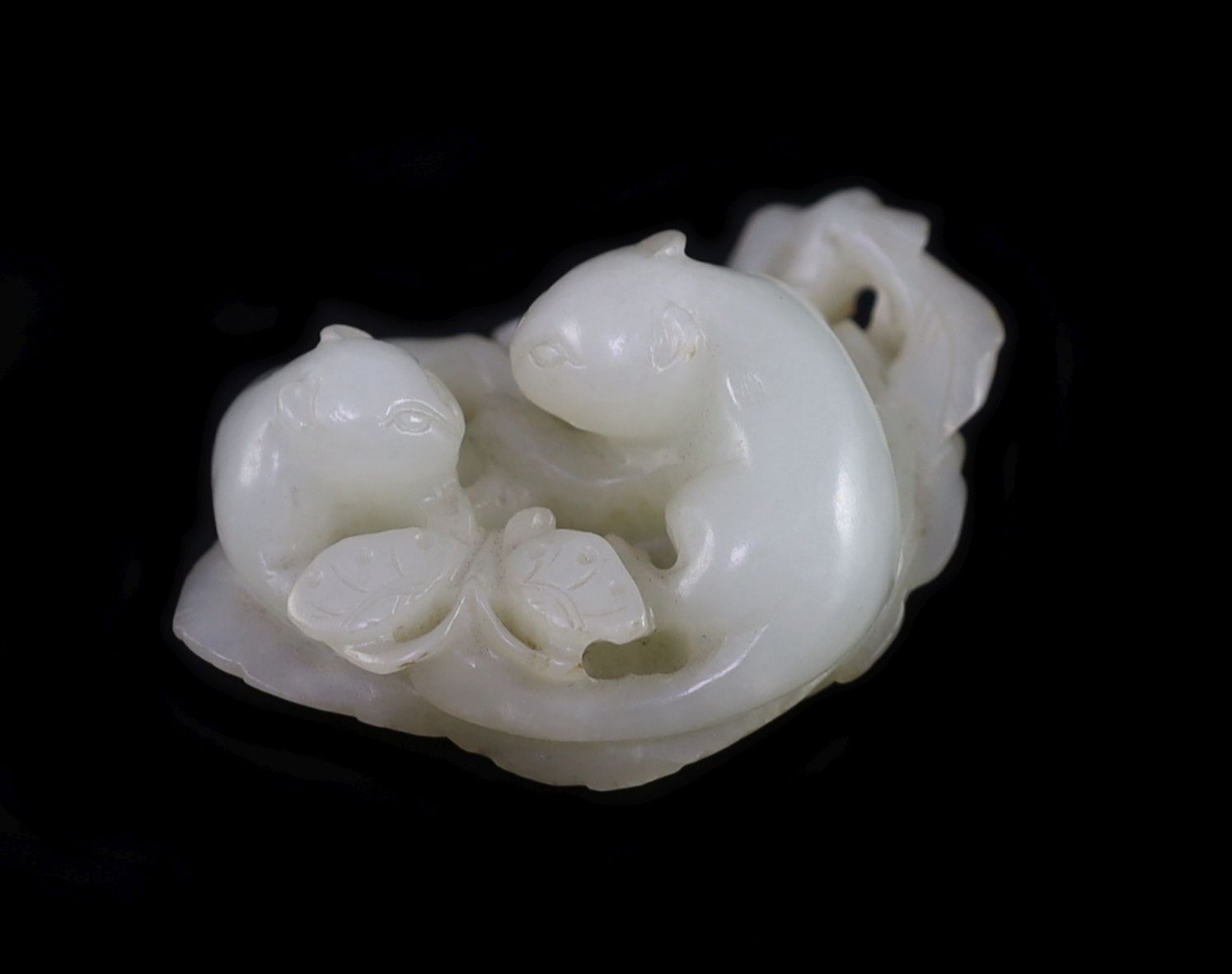 A Chinese pale celadon jade ‘cats and butterfly’ group, 18th/19th century, 6cm long